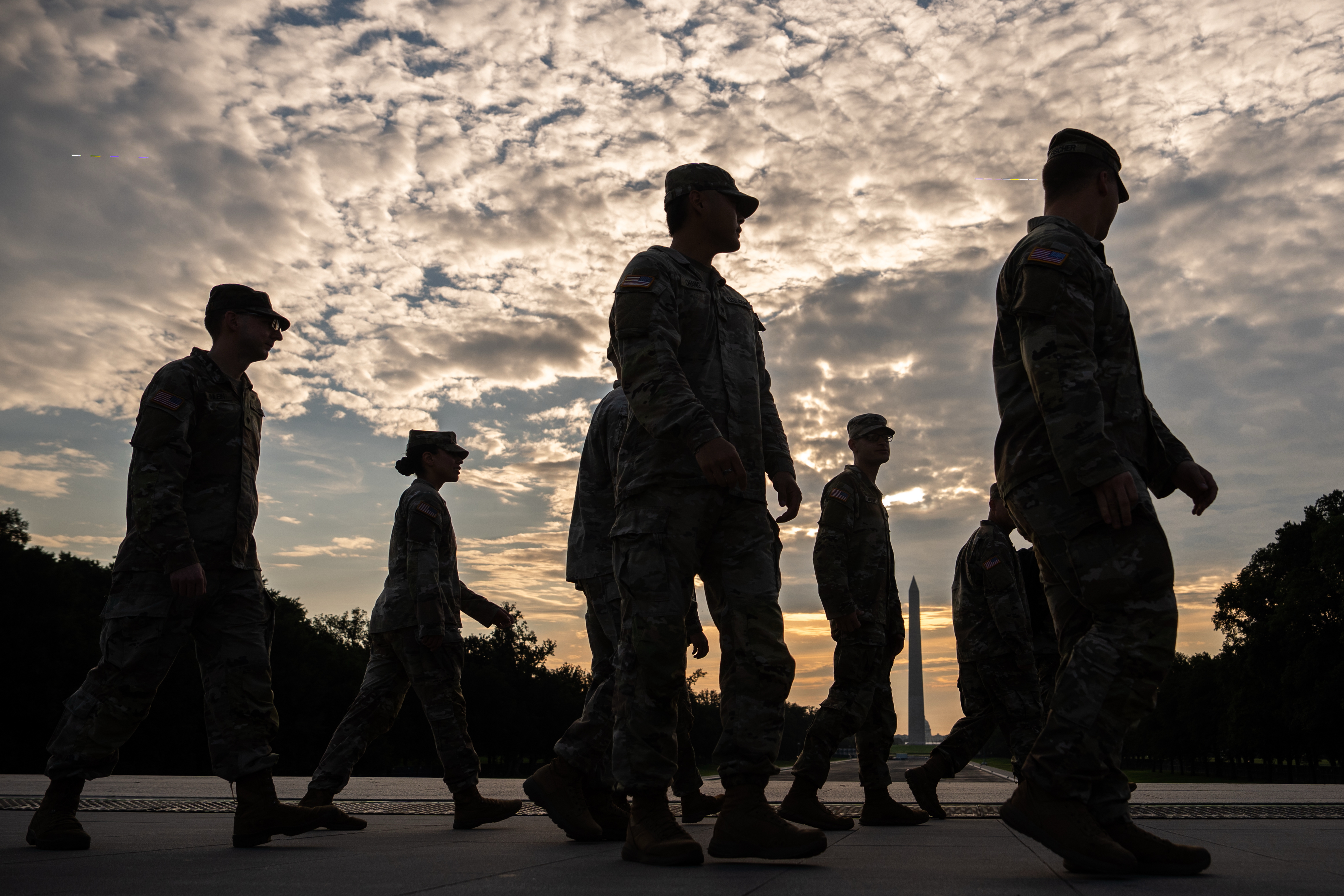 Members of the National Guard walk past the Lincoln Memorial Reflecting Pool before the March on Washington, Friday, Aug. 28, 2026, in Washington.